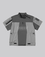 Black and gray techwear t-shirt with geometric color blocking and visual pocket accents creating an elongated avant-garde silhouette — view 2