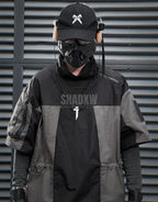 Black and gray techwear t-shirt with geometric color blocking and visual pocket accents creating an elongated avant-garde silhouette — view 4