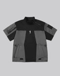 Black and gray techwear t-shirt with geometric color blocking and visual pocket accents creating an elongated avant-garde silhouette — view 1