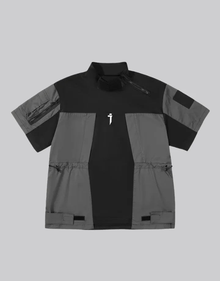 Black and gray techwear t-shirt with geometric color blocking and visual pocket accents creating an elongated avant-garde silhouette — view 1