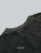 Muted grey oversized techwear t-shirt with a polished metallic heart emblem graphic and structured urban styling visible — view 4