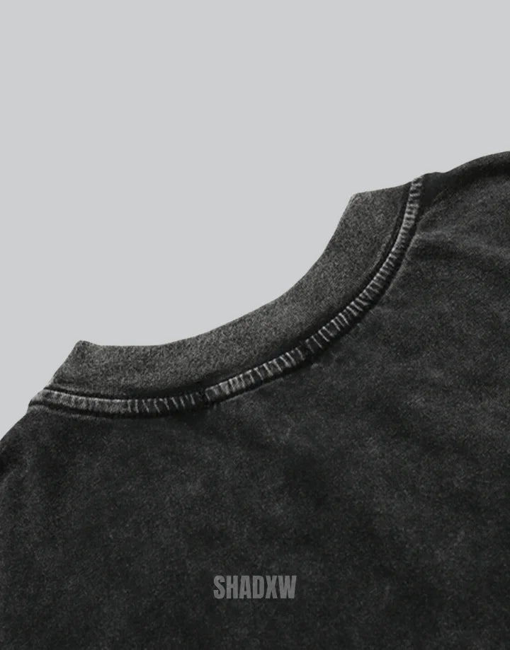 Muted grey oversized techwear t-shirt with a polished metallic heart emblem graphic and structured urban styling visible — view 4