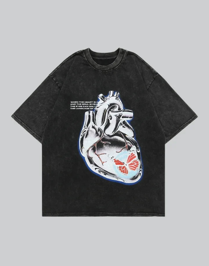 Muted grey oversized techwear t-shirt with a polished metallic heart emblem graphic and structured urban styling visible — view 1