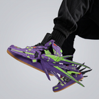 Purple and green winged sneakers worn in a lifted pose
