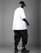 Monochrome oversized techwear shirt with minimalist paneling and extended hem in black and white options for contemporary streetwear looks — view 14