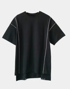 Black and white techwear t-shirt featuring a patterned light-responsive surface that brightens under illumination in urban styling — view 3