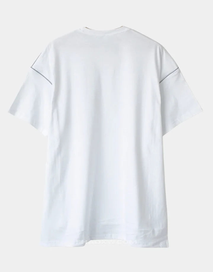 Black and white techwear t-shirt featuring a patterned light-responsive surface that brightens under illumination in urban styling — view 5
