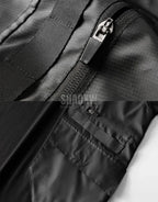 Black short-sleeve multi-pocket tech shirt with modular front panels and adjustable back drawcords in urban minimalist style — view 9