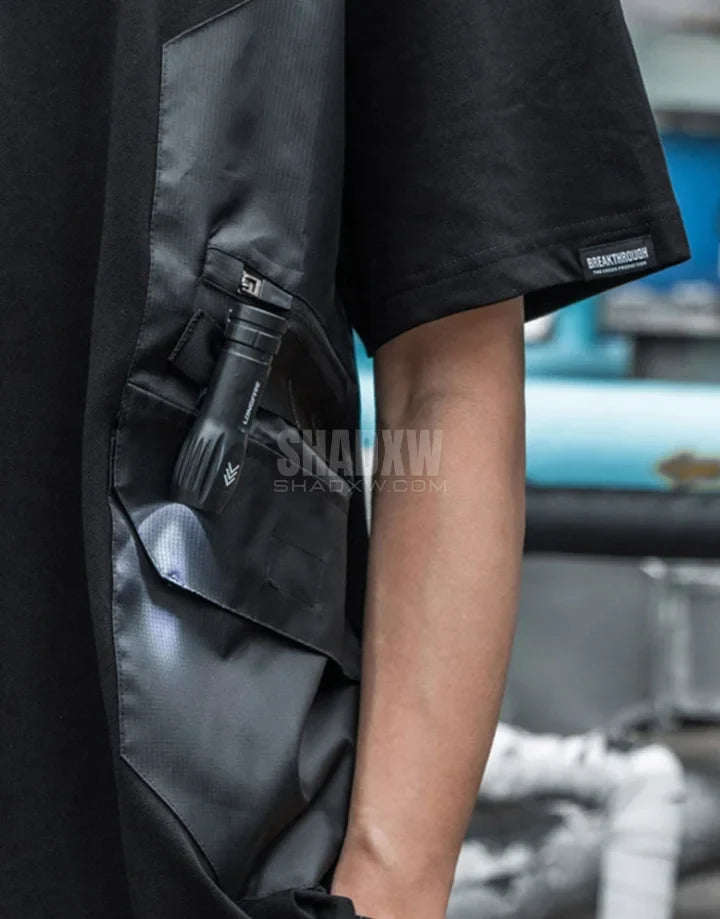 Black short-sleeve multi-pocket tech shirt with modular front panels and adjustable back drawcords in urban minimalist style — view 8