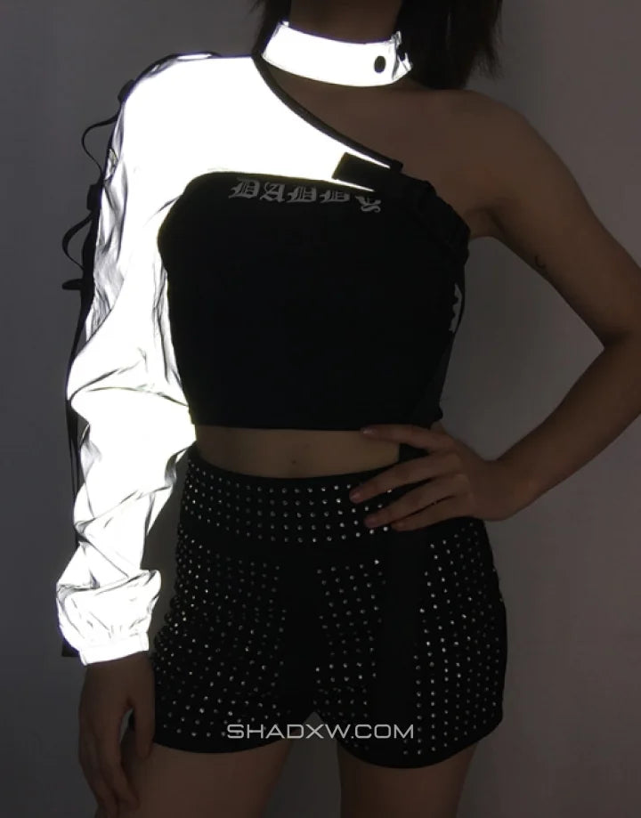 Asymmetric one-shoulder techwear top shown in black and reflective finish options with a sculptural shoulder line and modern urban styling — view 7