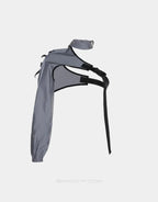 Asymmetric one-shoulder techwear top shown in black and reflective finish options with a sculptural shoulder line and modern urban styling — view 4