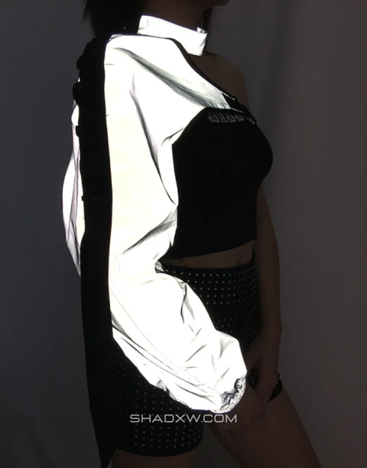 Asymmetric one-shoulder techwear top shown in black and reflective finish options with a sculptural shoulder line and modern urban styling — view 8