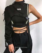 Asymmetric one-shoulder techwear top shown in black and reflective finish options with a sculptural shoulder line and modern urban styling — view 2