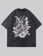 A dark gray mineral-wash short-sleeve t-shirt featuring a large graphic print of a horned devil character with a guitar and pistols amidst white waves, shown against a solid gray background.