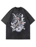 A dark gray mineral-wash short-sleeve t-shirt featuring a large graphic print of a horned devil character with a guitar and pistols amidst white waves, shown against a solid gray background.