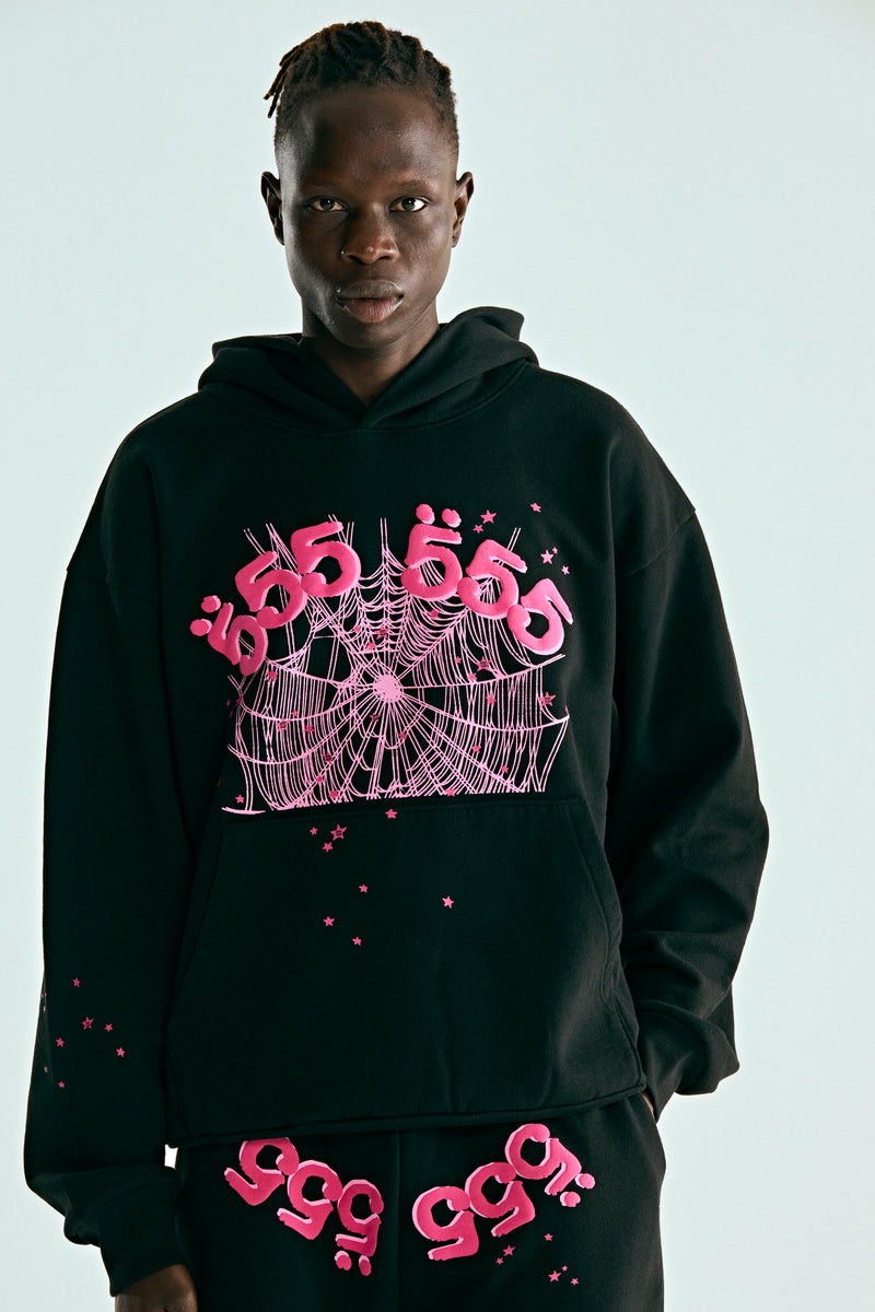 Detailed view of a man wearing the sp5der hoodie  555