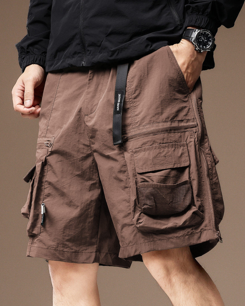 Brown cargo shorts worn by a person on a brown background