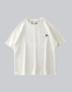 White short-sleeve techwear t-shirt with prominent black clip-closure front pocket and minimalist urban design details — view 2