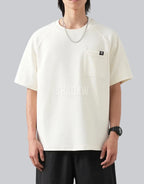 White short-sleeve techwear t-shirt with prominent black clip-closure front pocket and minimalist urban design details — view 3