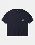 Women's short-sleeve techwear tee shown in black and white with a large center pocket and two smaller utility pockets on the front — view 1