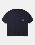 Women's short-sleeve techwear tee shown in black and white with a large center pocket and two smaller utility pockets on the front — view 1