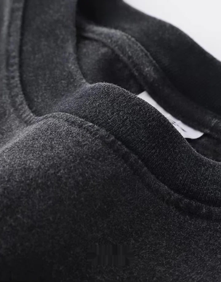 Oversized washed black techwear t-shirt with a long hem, muted charcoal finish, and minimalist urban streetwear styling — view 7