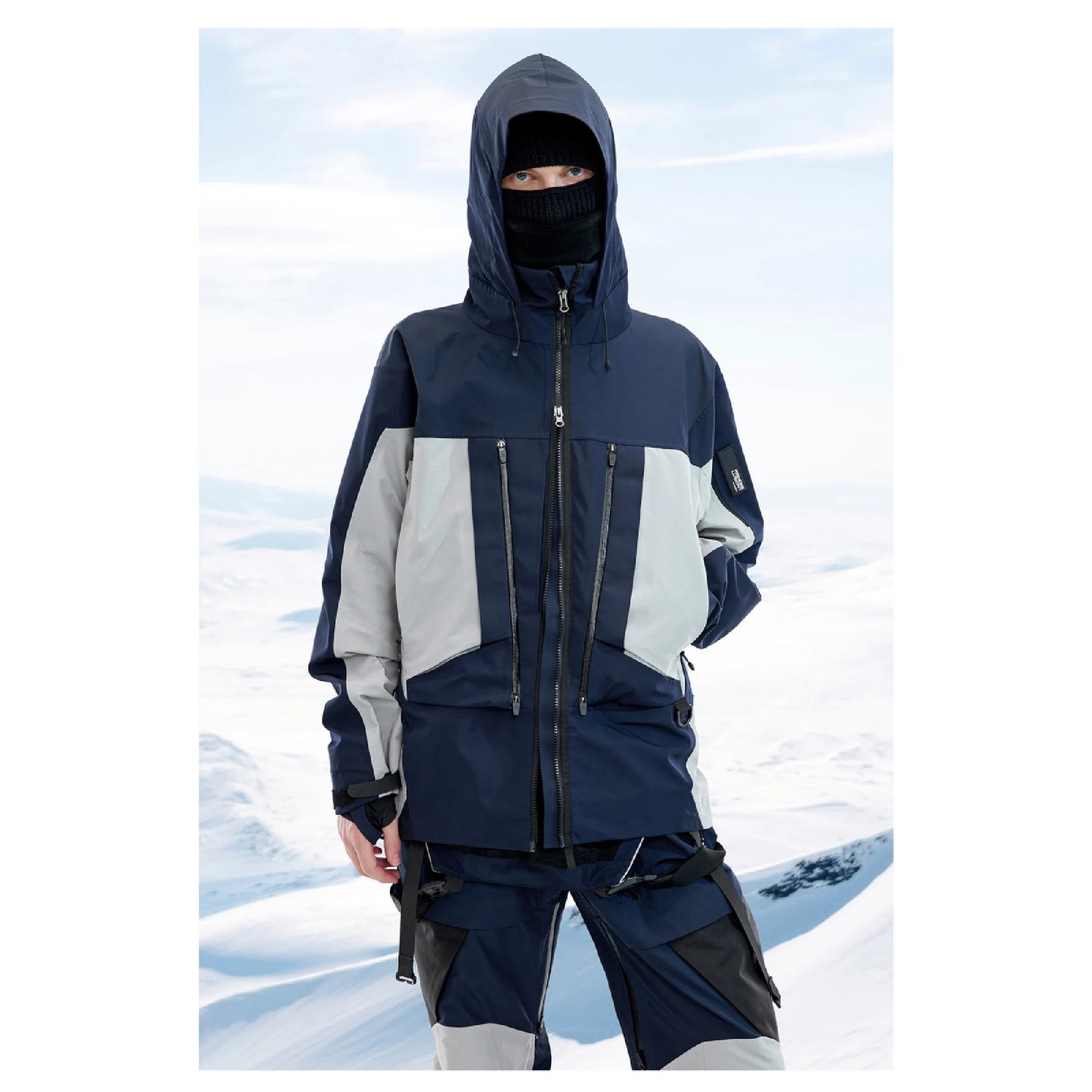 A man is wearing The 0107 Ski Down Techwear Jacket in blue Color