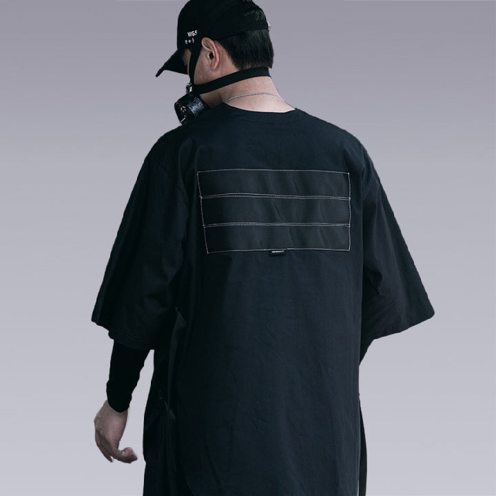 Man wearing THE DARK UNISEX TECHWEAR T-SHIRT